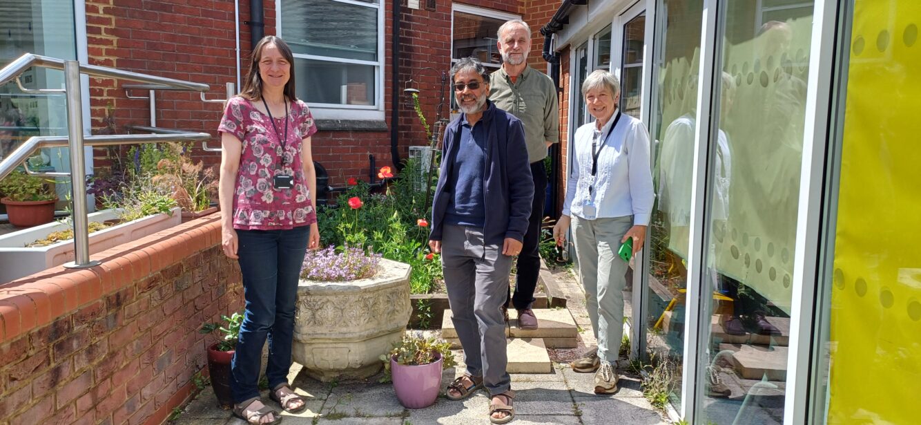 Four members of St John and St Stephen's Church in Reading's eco team stand in the courtyard area outside the church